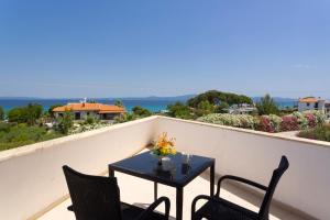 a table and two chairs on a balcony at Villa Helga Exotic in Pefkochori +108 photos