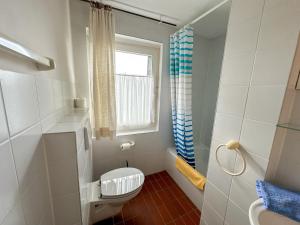 a small bathroom with a toilet and a window at Landhaus Stolper Wohnung 2 in Herzberg am Harz +26 photos