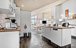 a kitchen with white cabinets and a counter at 4 Bedroom Lovely Home In Faaborg in Fåborg