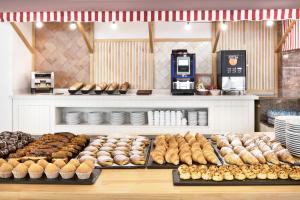 a bakery with a bunch of different types of donuts at tent Playa de Palma in Playa de Palma