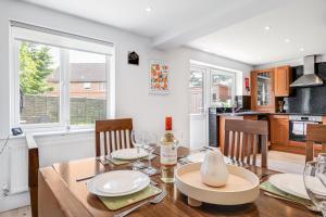 a dining room with a table and chairs and a kitchen at Comfortable Home away from Home with FREE Parking in Northampton