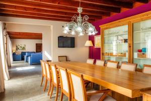 a dining room with a wooden table and chairs at Finca Conies Romaní in Manacor