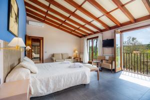 a bedroom with a bed and a balcony at Finca Conies Romaní in Manacor +30 photos
