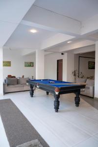 a pool table in a living room with a couch at Le Papillon By Bay Hotels in Lonavala