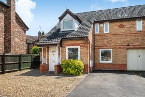 a red brick house with a white garage at Comfortable Home away from Home with FREE Parking in Northampton