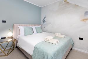 a bedroom with two beds with towels on a table at Mint & Gold Luxury Suite in Malinska