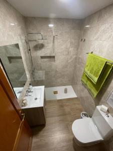 a bathroom with a shower and a toilet and a sink at Vivienda Vacacional C & M in Puerto del Rosario