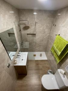 a bathroom with a shower and a toilet and a sink at Vivienda Vacacional C & M in Puerto del Rosario