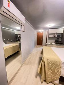 a large room with a bed and a kitchen at Blue Sunset Flats Beira Mar - Apt 322 in João Pessoa