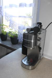 a black coffee maker sitting on a counter at Apartament Kalwaria Piekary in Piekary Śląskie +19 photos