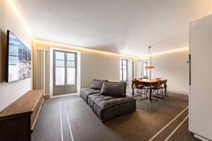 a living room with a couch and a table at Alp Apartments SKI & BIKE - Ansermin in Aosta
