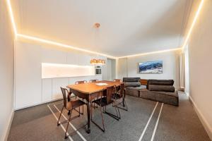 a kitchen and dining room with a table and a couch at Alp Apartments SKI & BIKE - Ansermin in Aosta