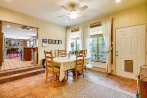 a dining room with a table and chairs and a ceiling fan at Quiet Home with Garden about 7 Mi to Patagonia Lake! in Patagonia