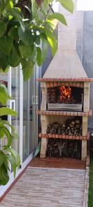 a stone outdoor oven with a fire in it at El Jardín y Mar in O Barqueiro