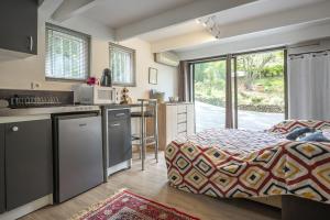 a room with a kitchen and a bed in it at Studio - les Adrets Esterel in Fréjus
