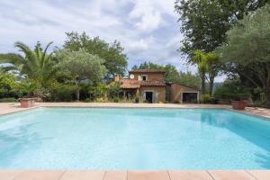 a large swimming pool in front of a house at Studio - les Adrets Esterel in Fréjus