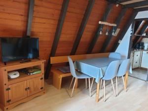 a dining room with a table and chairs and a television at Ferienhaus Toso in Freyung