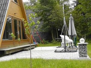 a patio with an umbrella and a chair and an umbrella at Ferienhaus Toso in Freyung