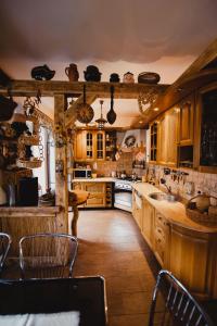 a kitchen with wooden cabinets and a table and chairs at Agrousadba Nad Nemanom in Byarozawka