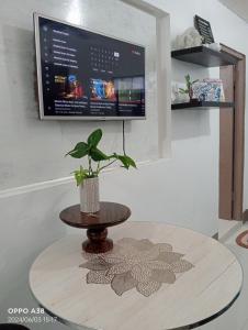 a table with a plant sitting on top of it at RY Nest in Malaybalay