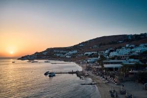 a view of a beach with boats in the water at Hippie Chic Hotel in Agios Ioannis Mykonos