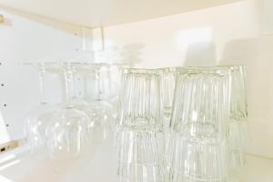 a row of clear glasses sitting on a wall at Bellecour Prestige-Coeur de Lyon in Lyon +25 photos