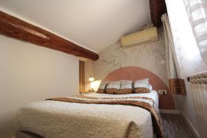 a bedroom with a large bed in a room at H&ocirc;tel Des Arts, Artisanal et Ind&eacute;pendant in Montpellier