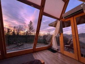 a room with a large window with a view at Lovely Chalet in Tuzla