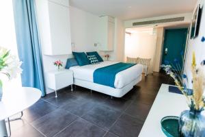 a bedroom with a bed and a room with a table at Hotel 54 Barceloneta in Barcelona