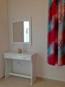 a bathroom with a white vanity and a mirror at Papanikola House 2 in Astypalaia +14 photos