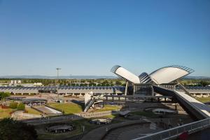 a view of a building with a train station at Moxy Lyon Airport in Saint-Exupéry