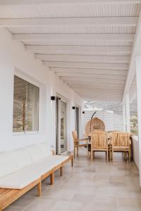 an open living room with a table and chairs at Sea sound in Mylopotas