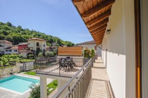 a balcony with a view of a swimming pool at Le Casette di Orta Apartments in Orta San Giulio