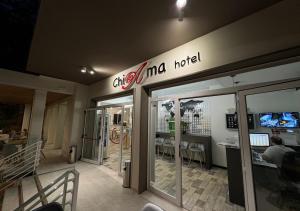 a store with a sign on the side of a building at chiAma Hotel in Rimini