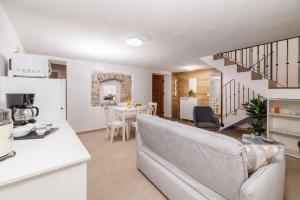 a kitchen and living room with a couch and a table at Holliday house Smokvica in Jadranovo