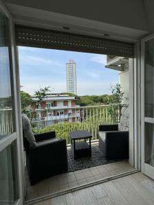 a balcony with couches and a table and a building at Charm in centre, sunset, movida! in Milano Marittima