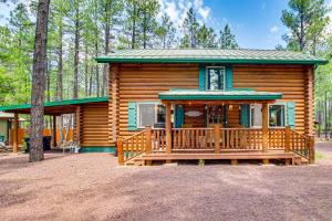 a log cabin with a large porch in the woods at Near Dining, Hiking and Golf Pinetop Log Cabin! in Indian Pine