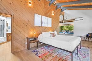 a bedroom with a bed and a wooden wall at Basecamp Lodge in Mount Shasta
