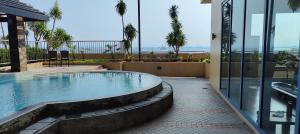 a swimming pool in the middle of a house at Grand Riviera Suites in Manila