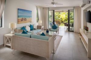 a living room with a couch and chairs at Beach View Hotel in Saint James