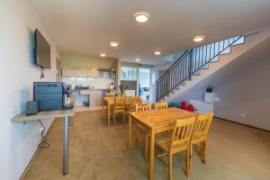 a kitchen and dining room with a wooden table and chairs at Spokojne Wczasy in Mielno