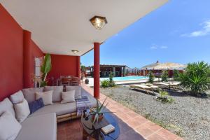 a living room with a white couch on a patio at Ca'Sita Salobre Pueblo by VillaGranCanaria in San Bartolomé de Tirajana