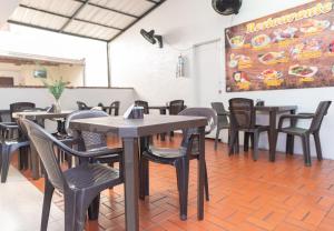 a dining room with tables and chairs in a restaurant at Hotel Conquistadores in Medellín