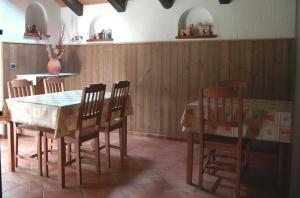 a dining room with a wooden table and chairs at B&B della Miniera in Cogne