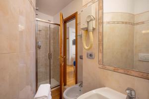 a bathroom with a shower and a toilet and a sink at Hotel Annabella Roof Terrace in Florence +58 photos