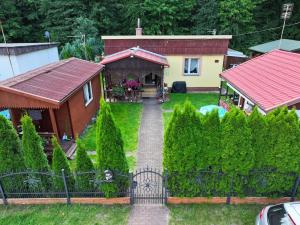 a house with a garden with a pathway leading to it at Domki u Dorotki in Jantar