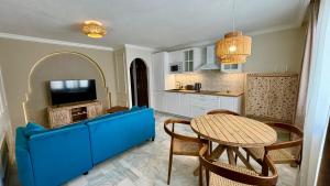a kitchen with a blue couch and a table at Casa Veranera Vera Costa in Playas de Vera