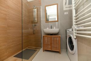 a bathroom with a sink and a washing machine at Luxury Apartment Skyline in Split +36 photos
