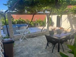 a patio with a table and chairs and a pool at Holiday Home Kristin in Mirce