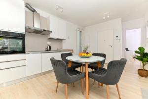 a kitchen and dining room with a table and chairs at Luxury Apartment Skyline in Split